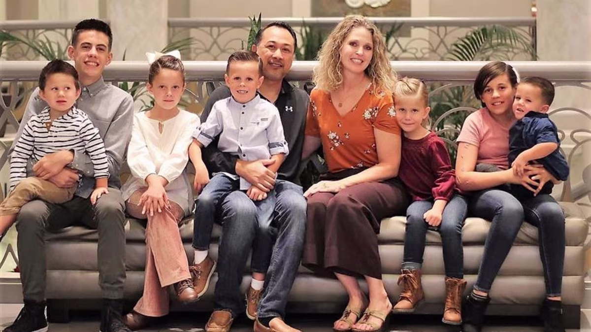 Family vacation photo at Elara, a Hilton Grand Vacations Club in Las Vegas after couple adopts seven siblings in foster care.