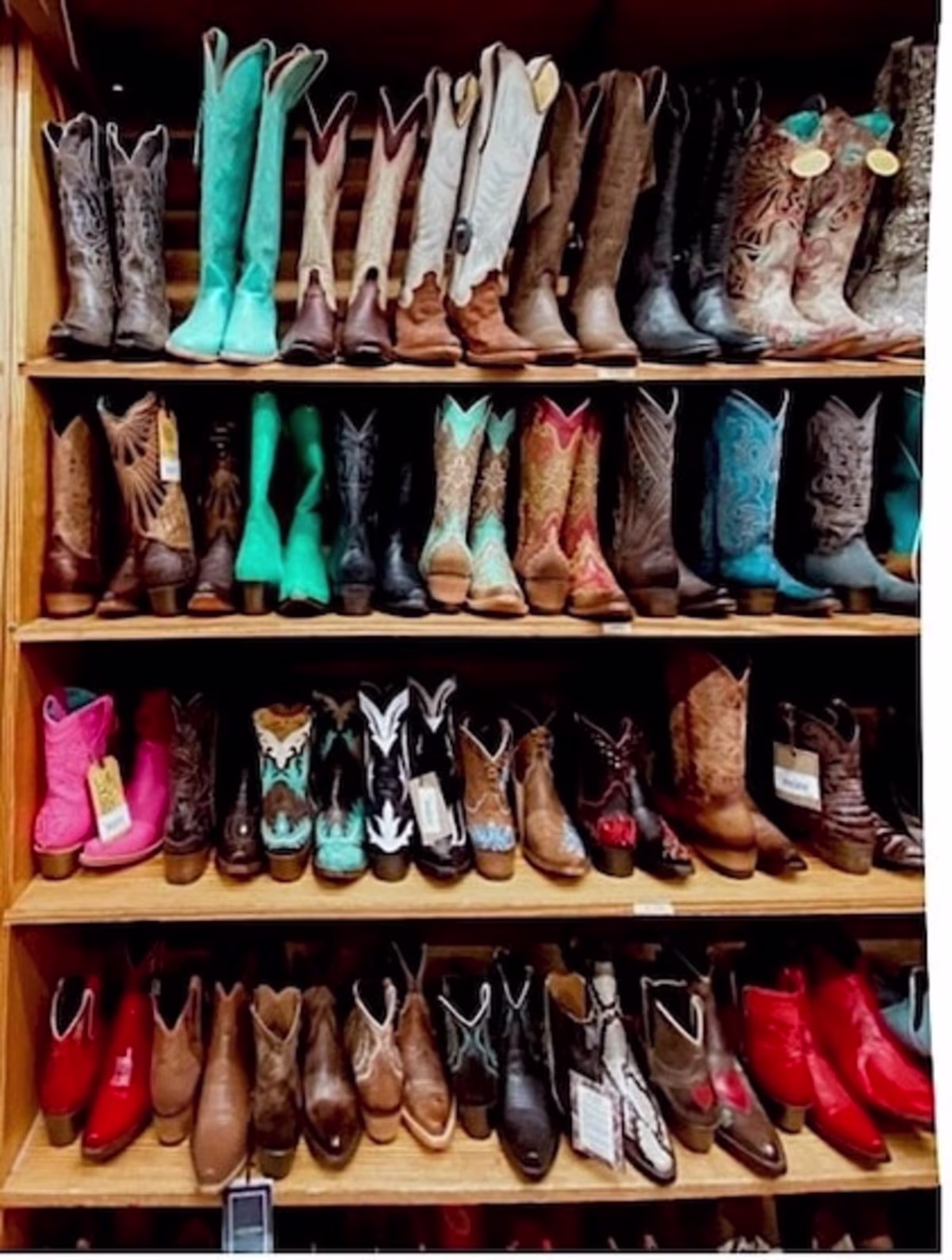 Rows of shelving displaying colorful cowboy boots at Allens Boots in Austin Texas