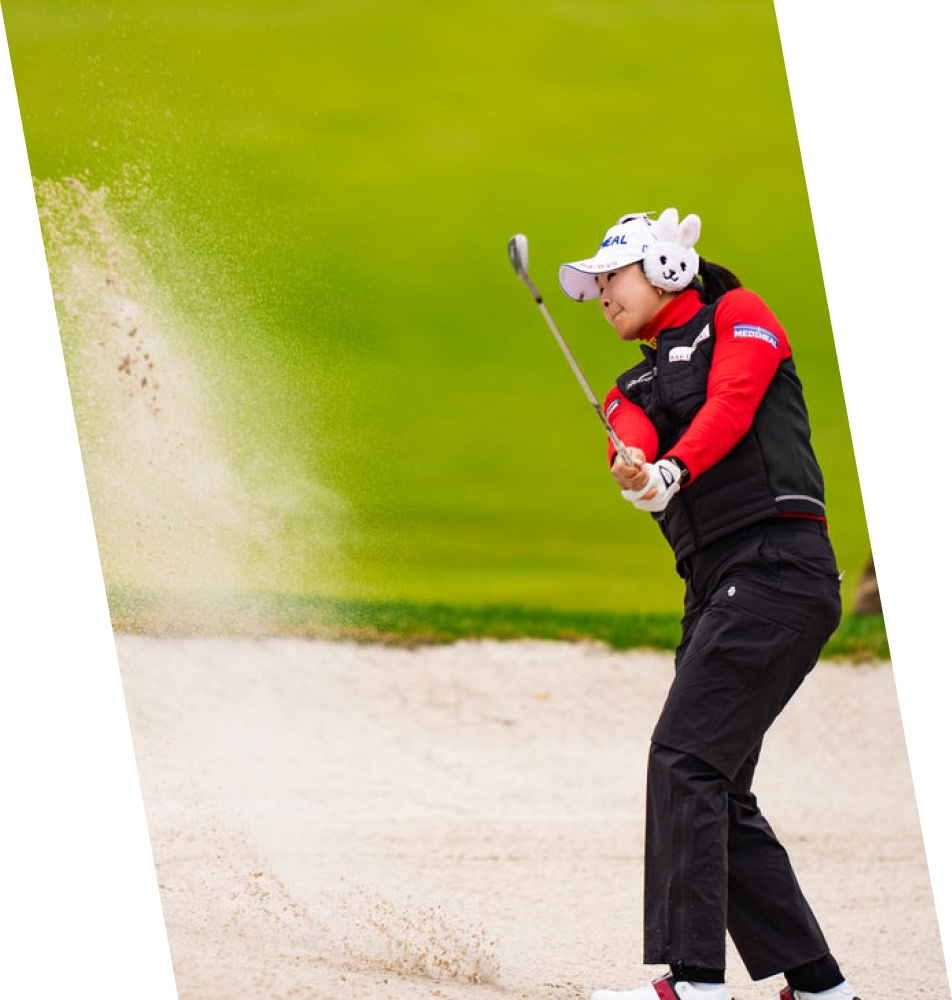 woman swinging golf club