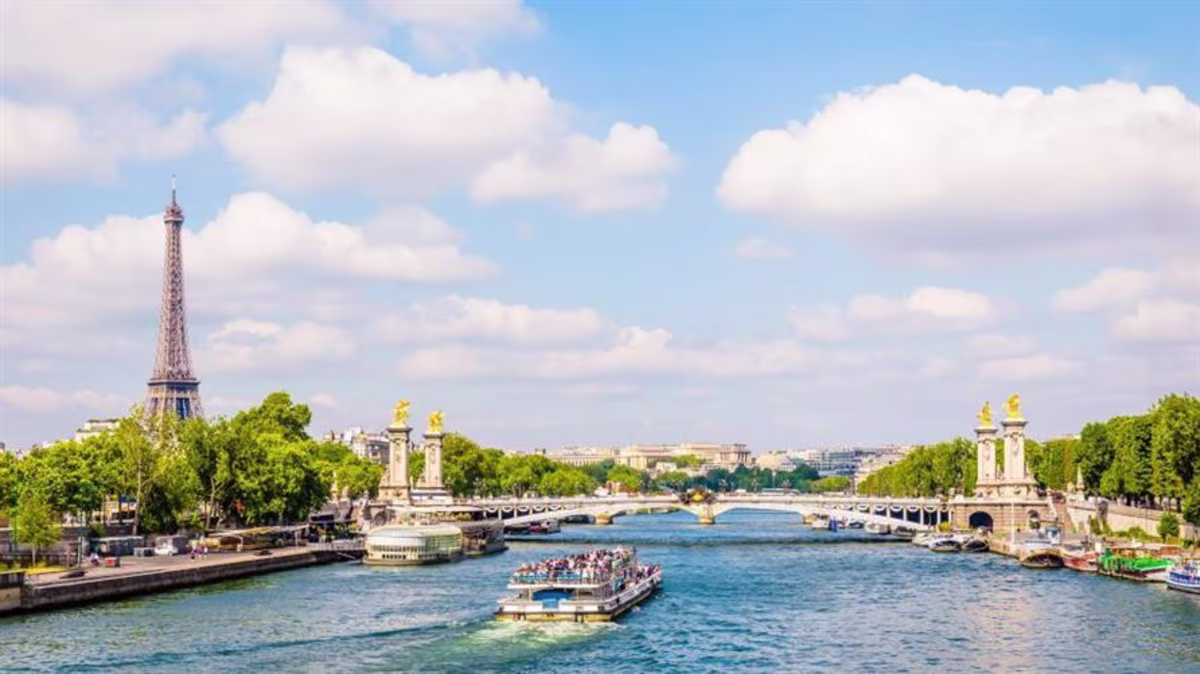 The Eiffel Tower in Paris overlooking the Seine River and a boat cruise