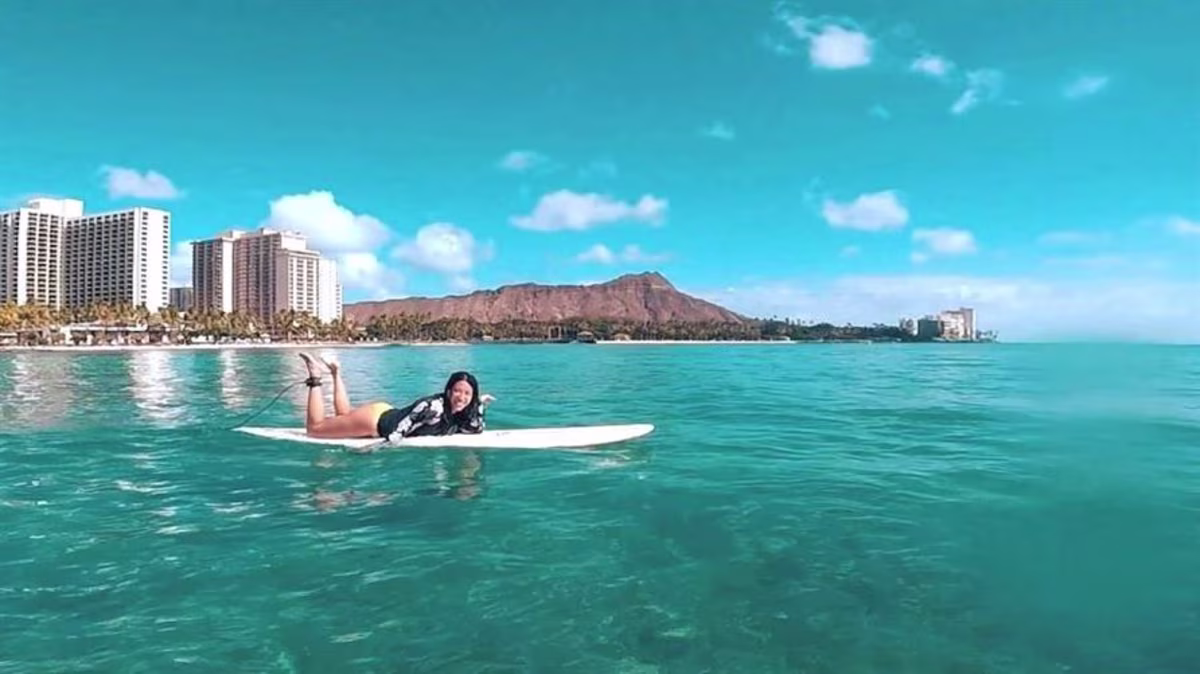A Hilton Grand Vacations Member surfs in Oahu, Hawaii