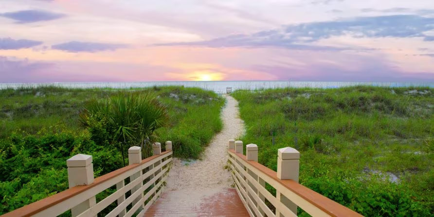 Stunning sunset beach image, wooden walkway leading to beach, white sands, sunset painted skies overhead, Hilton Head, South Carolina.