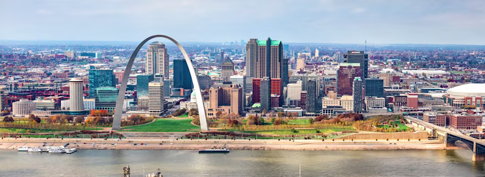 St. Louis cityscape in bright daylight, featuring its iconic arch.