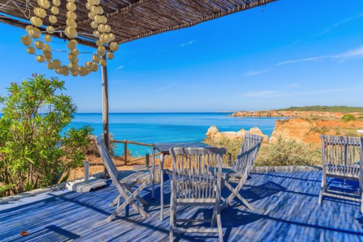 Beautiful image, table and chairs, outdoor seating, stunning coastline, Algarve, Portugal.