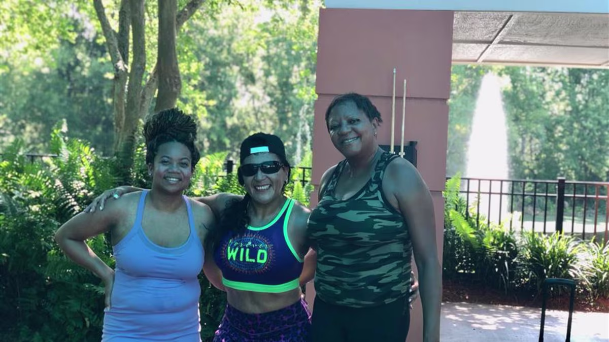 Hilton Grand Vacations Owner posing with friends after a workout at a Hilton Grand Vacations resort.