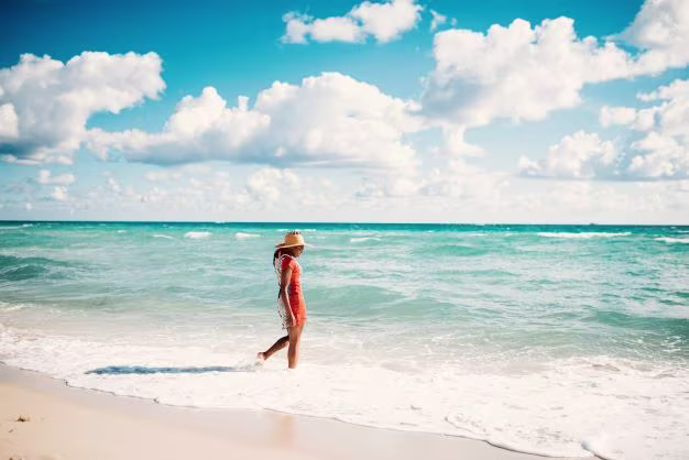 Woman of color walking along Miami Beach, Florida. 