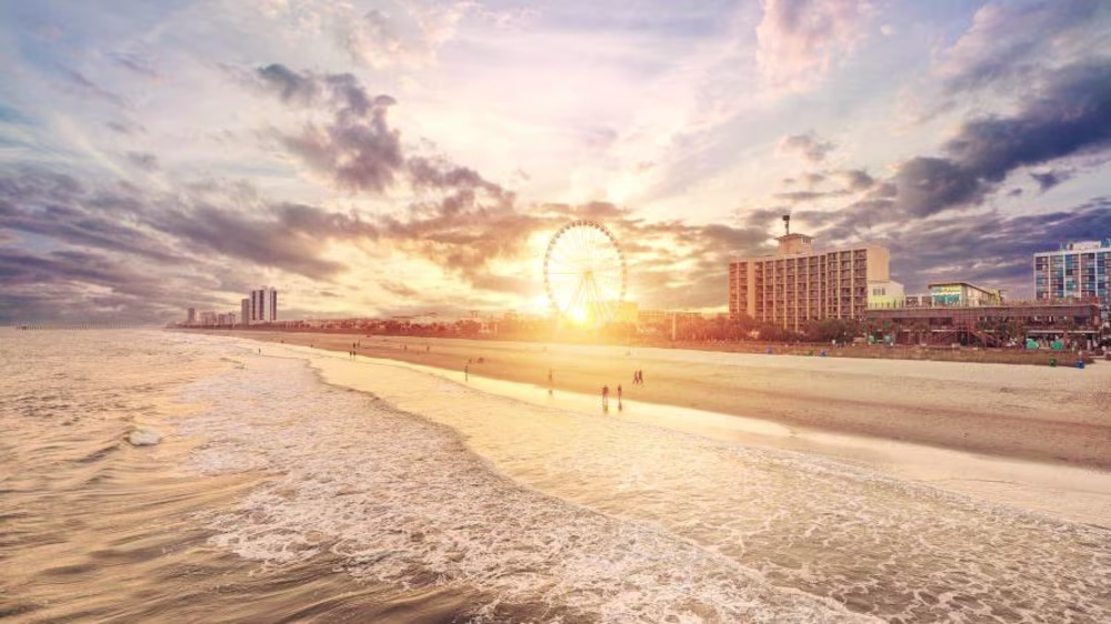 Gorgeous aerial image, sunset painted skies, Myrtle Beach Grand Strand, SkyWheel in the distance, South Carolina.