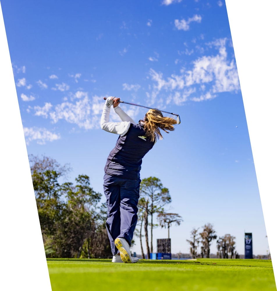 Female golfer swining club
