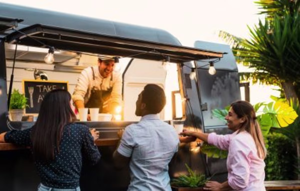 Group of people, happily ordering food, food truck.