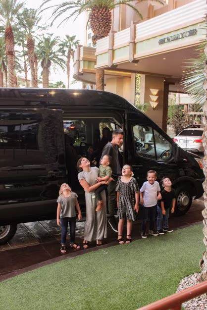 The Willis children outside of a Hilton Grand Vacations resort, looking up in awe