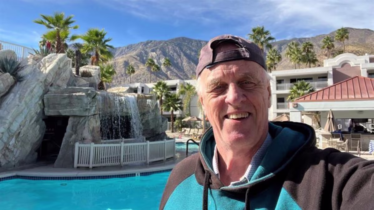 A Hilton Grand Vacations Member takes a selfie at the pool at Palm Canyon Resort in Palm Springs, California