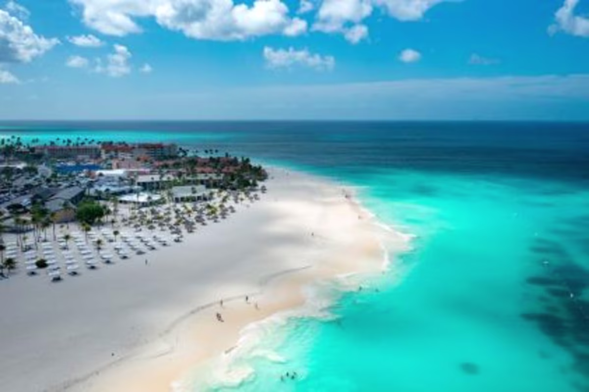 Aerial image, crystal clear turquoise water washes ashore white sands, Eagle Beach, Aruba.