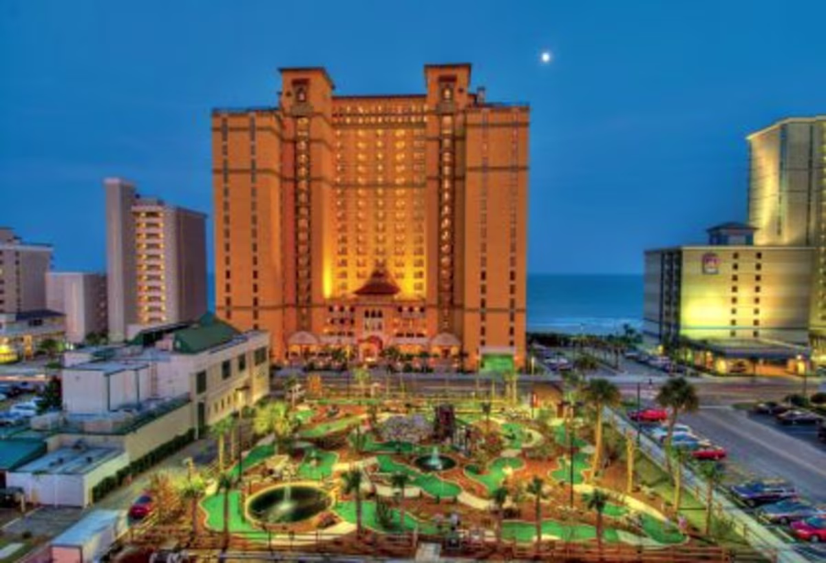 Anderson Ocean Club, a Hilton Grand Vacations Club glow against night sky, exclusive mini-golf course, Myrtle Beach, South Carolina.