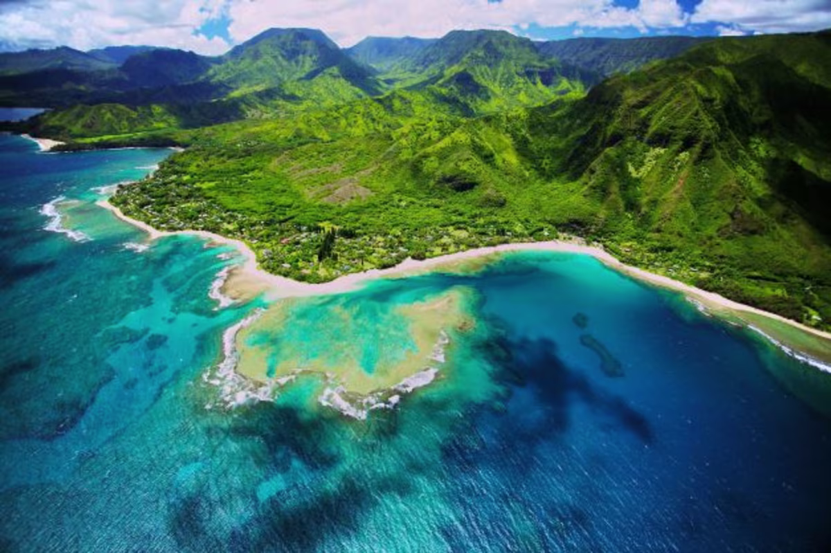 Stunning aerial image, emerald cliffs, turquoise water, Kauai, Hawaii.