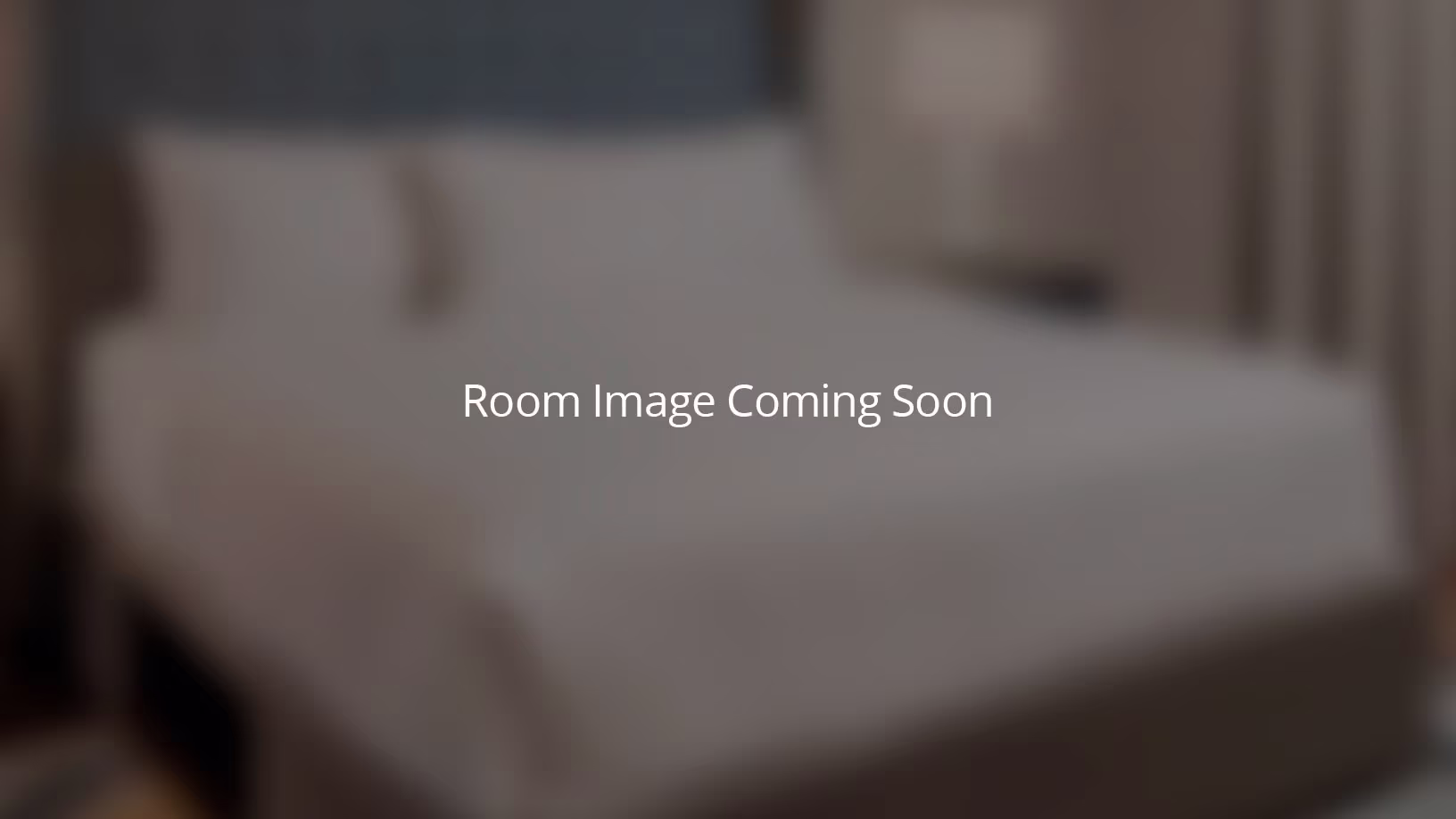 Blurred image of a bedroom with text overlay: Room Image Coming Soon