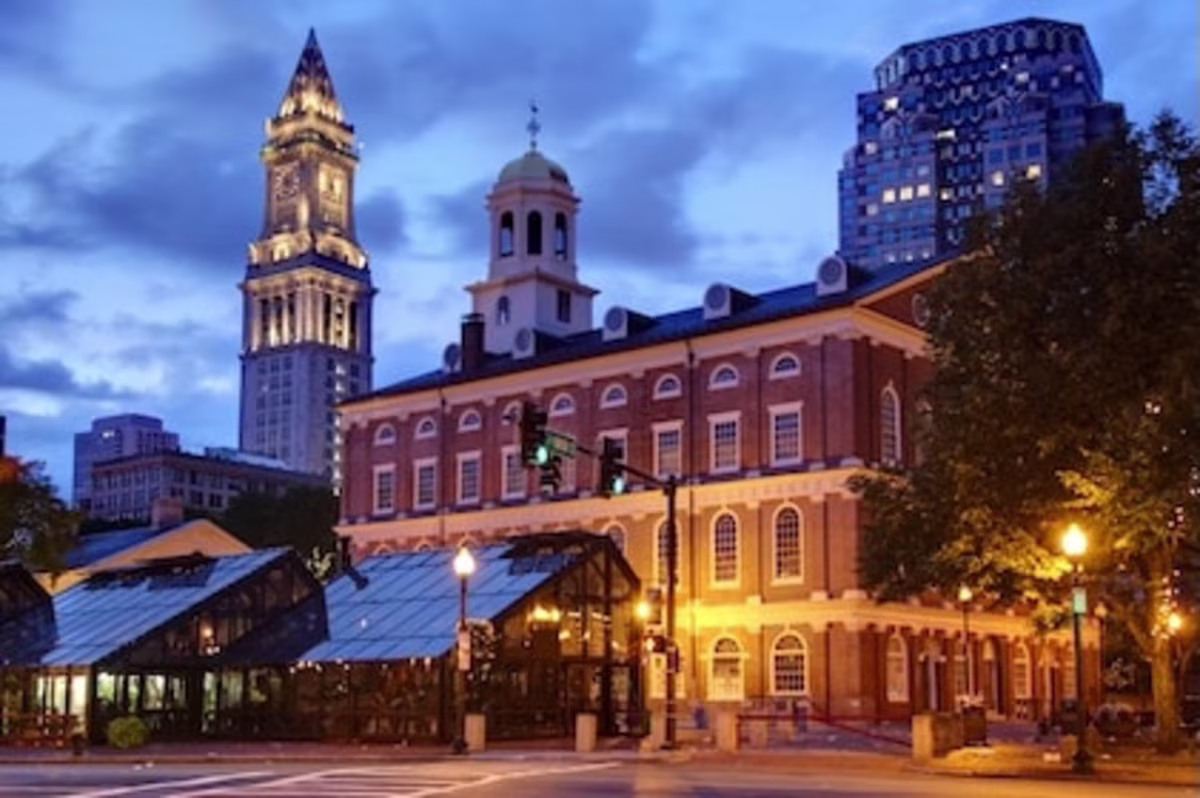 Street view of Faneuil Hall in Boston, Massachusetts and surrounding buildings in the distance.