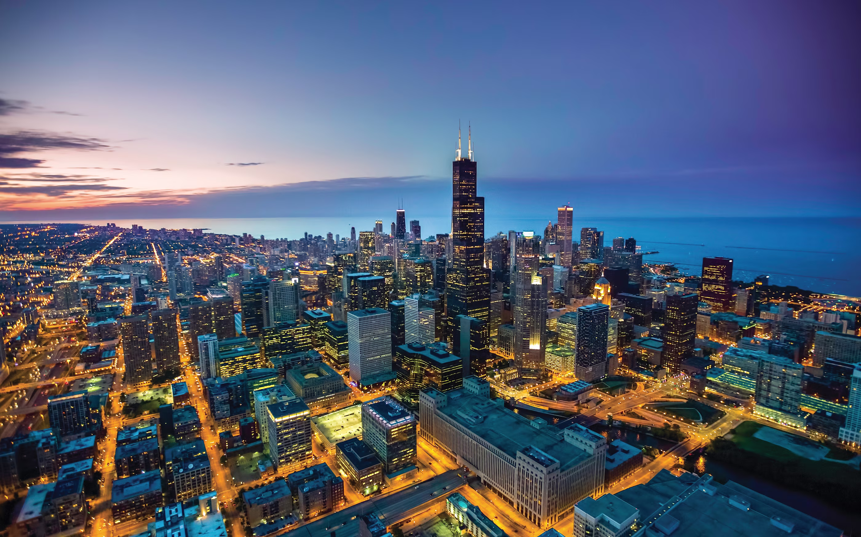 Aerial view of the glittering Chicago skyline at late sunset.
