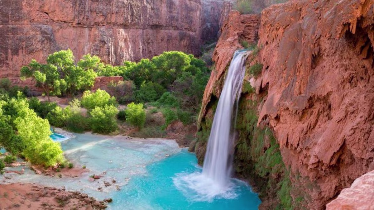 Beautiful turquoise waterfall, red rocks, American Canyonlands, Utah.
