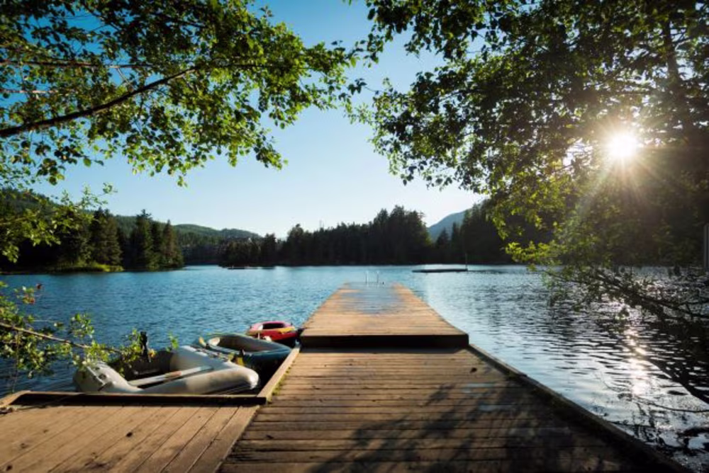 Dock with kayaks at Alpha Lake near Whistler, Canada, in summer